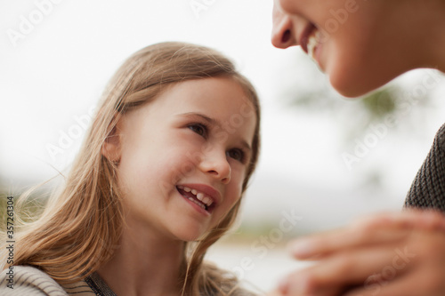 Close up of smiling daughter looking up at mother