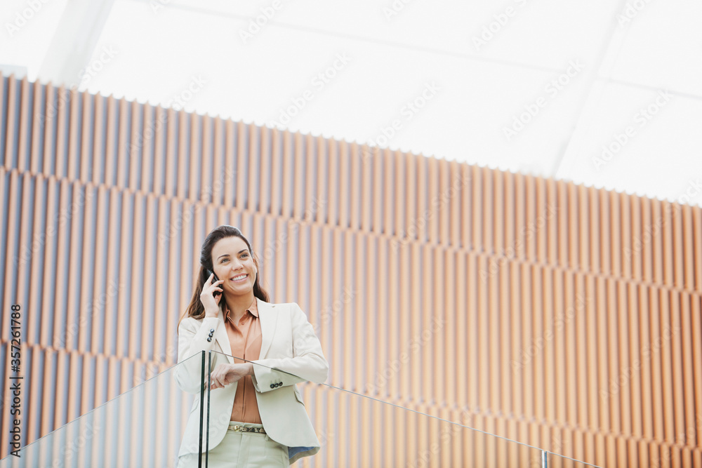 Smiling businesswoman talking on cell phone Smiling businesswoman talking on cell phone