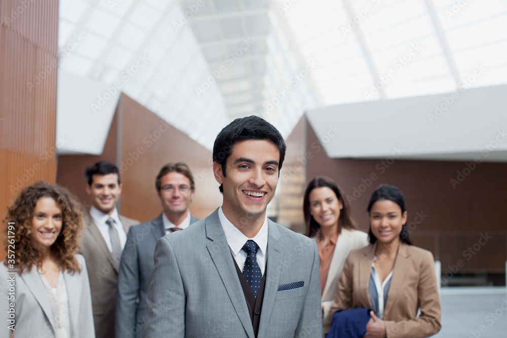 Portrait of confident business people in modern lobby Portrait of confident business people in modern lobby