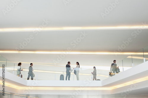 Business people on elevated walkway in airport photo