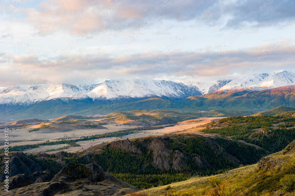 beautiful sunrise, an amazing view of the Altai mountains covered with snow, the autumn steppe, the Chuya river.