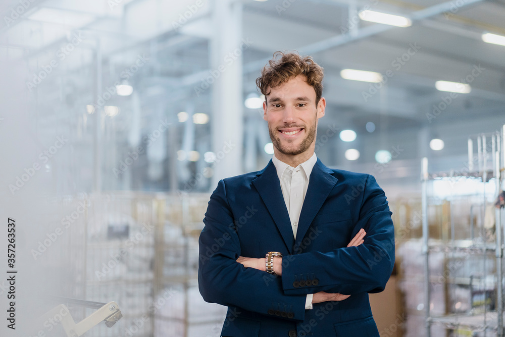 Portrait of a smiling young businessman in a factory Portrait of a smiling young businessman in a factory