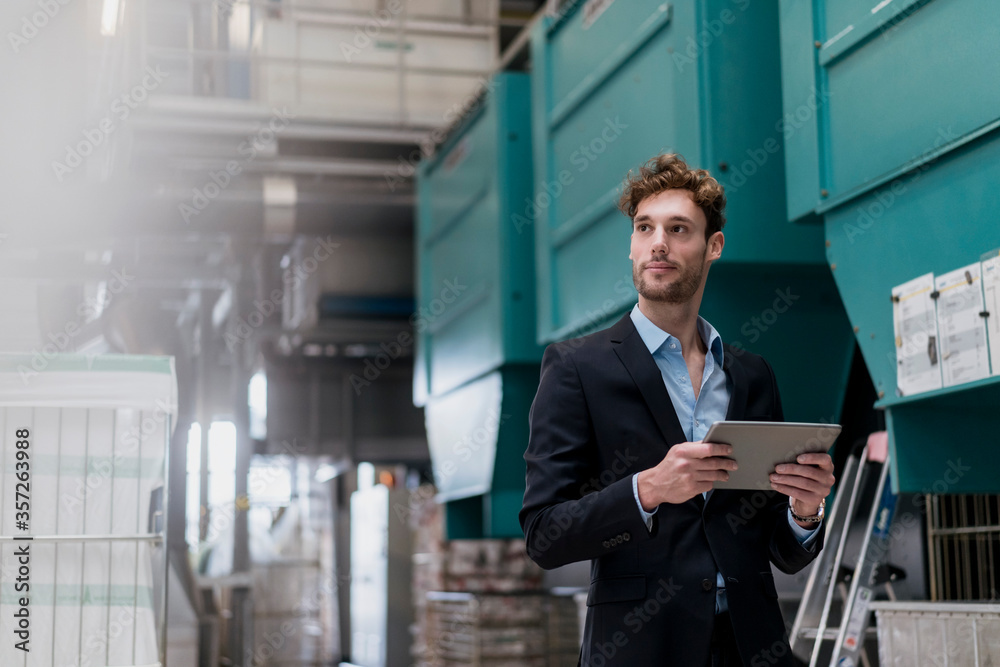 custom made wallpaper toronto digitalYoung businessman holding tablet in a factory