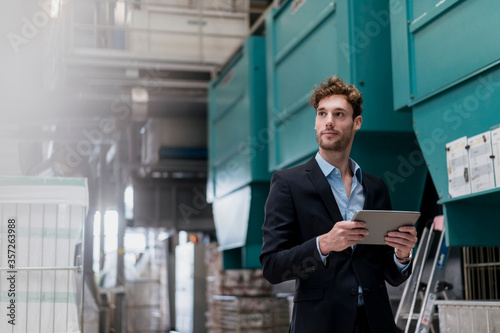 Wallpaper Mural Young businessman holding tablet in a factory Torontodigital.ca
