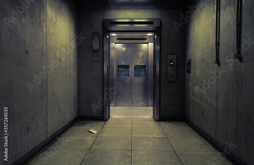 Futuristic Steel Elevator At The End Of A Concrete Corridor