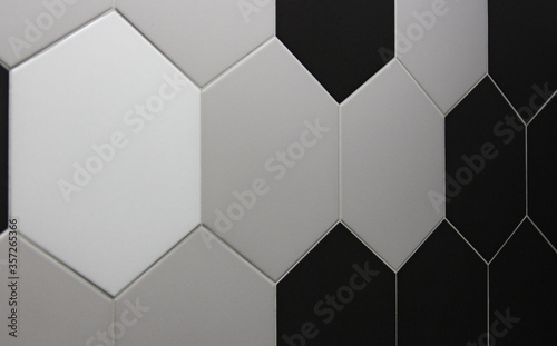Black and white and gray ceramic tiles with geometric patterns for wall and floor decoration. Concrete surface background. Texture for interior design project.