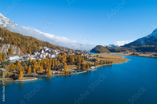 Switzerland, Canton of Grisons, Saint Moritz, Drone view of town on forested shore of Lake?Silvaplana?in autumn photo