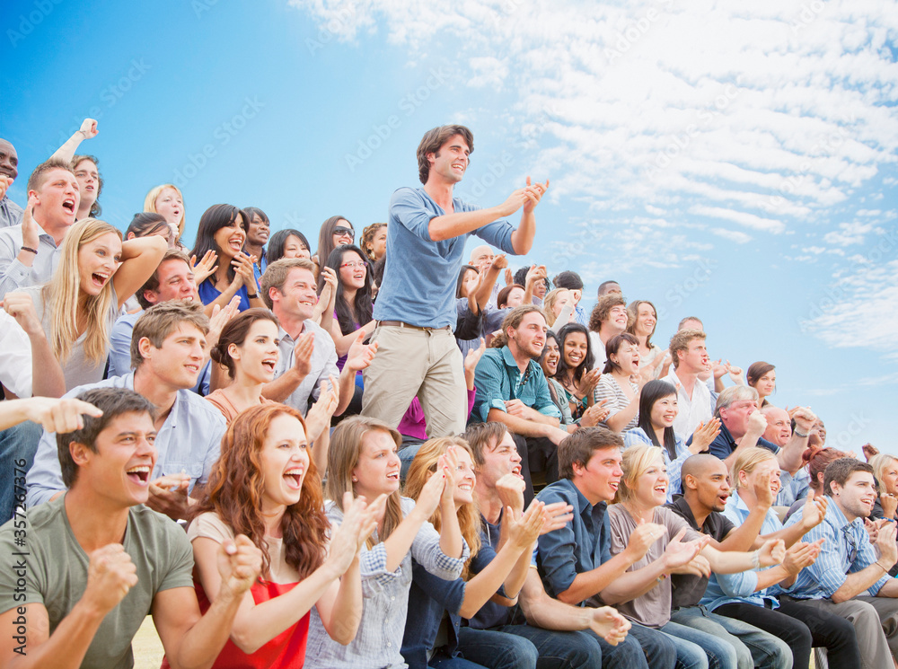 Man Standing And Clapping Among Cheering Crowd Stock Photo Adobe Stock