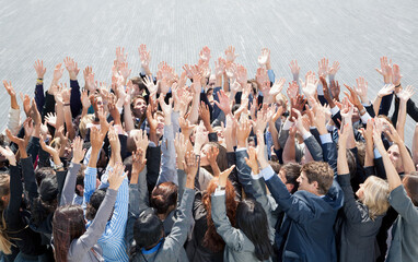 Crowd of business people cheering with arms raised
