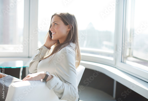 Businesswoman talking on phone in office Free Download Businesswoman talking on phone in office - GFXLoad