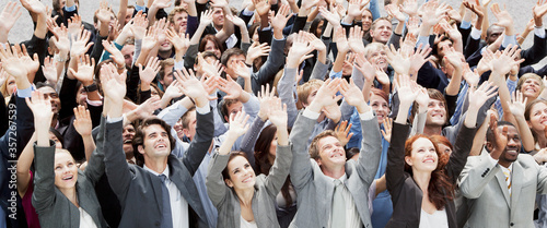 Crowd of business people cheering with arms raised