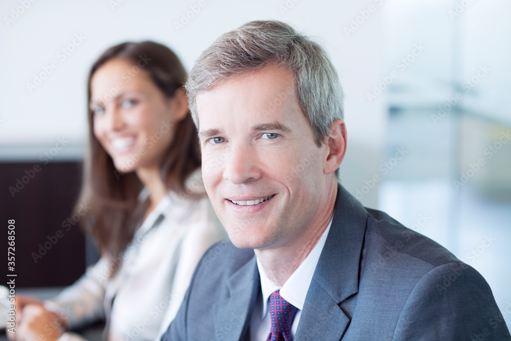 Businessman smiling in meeting Businessman smiling in meeting