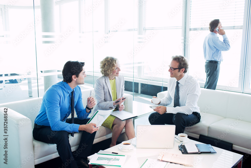 Business people talking in office lobby