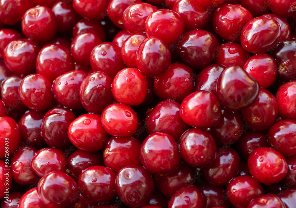 Red and tasty cherry texture, background. The benefits of cherries Red and tasty cherry texture, background. The benefits of cherries