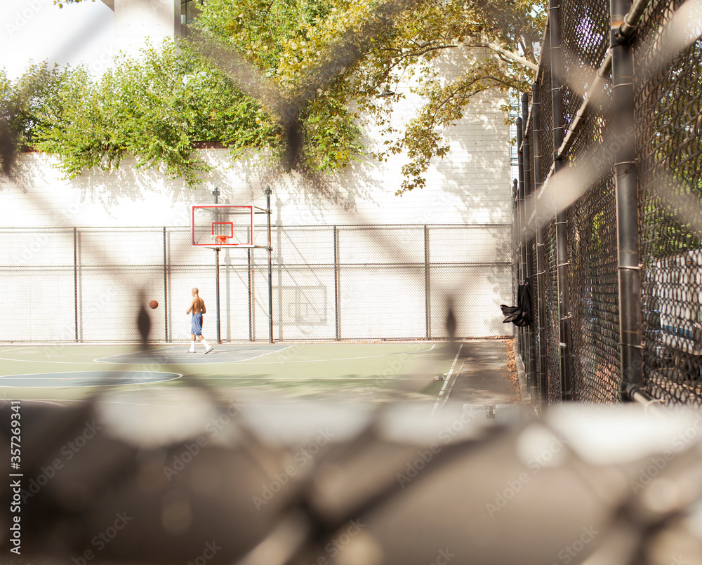 Man playing basketball on urban court Man playing basketball on urban court