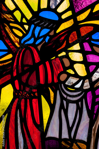  Colorful stained glass window of Jesus carrying the cross