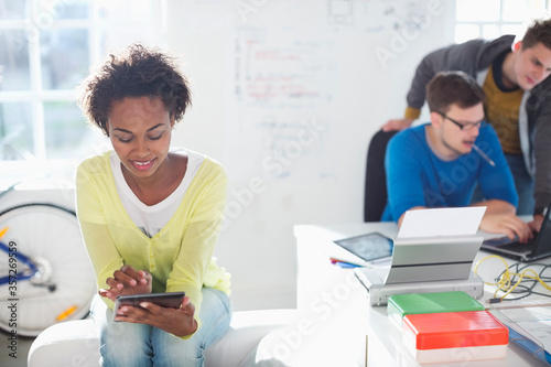 Businesswoman using digital tablet in office photo