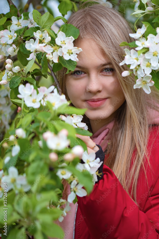 Portrait of a girl among the branches of a flowering Apple tree Portrait of a girl among the branches of a flowering Apple tree
