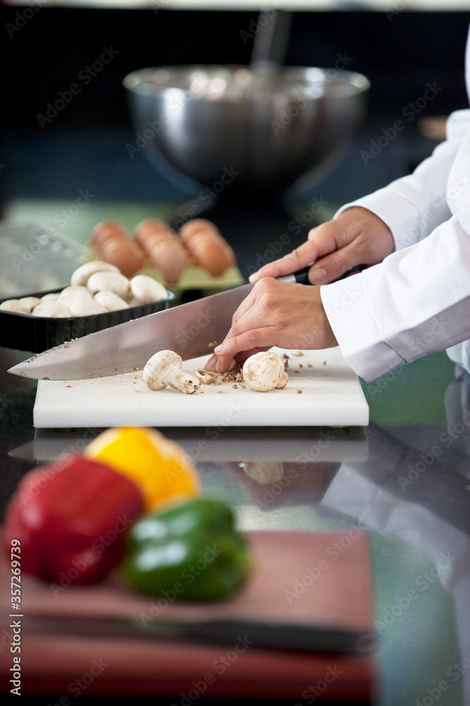 Chef chopping vegetables in restaurant kitchen