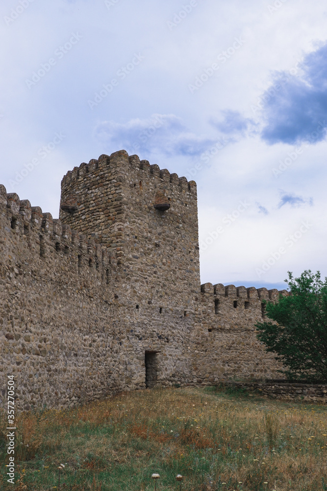 Old Georgian fortress. Stone walls of the tower in Georgia. Kakhetia. Old Georgian fortress. Stone walls of the tower in Georgia. Kakhetia.