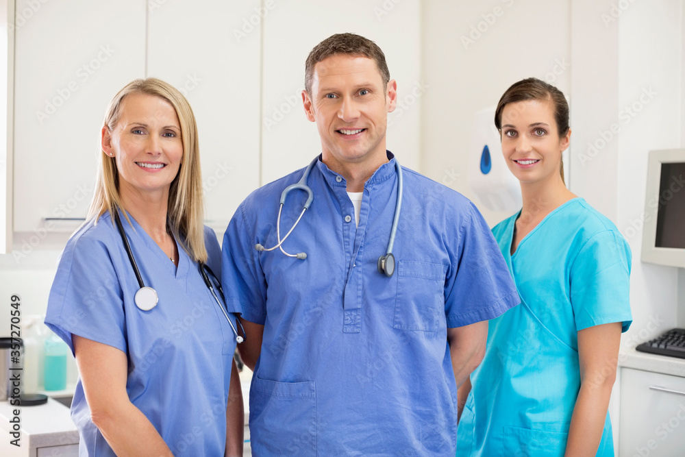 Smiling veterinarians standing together in vet's surgery Smiling veterinarians standing together in vet's surgery