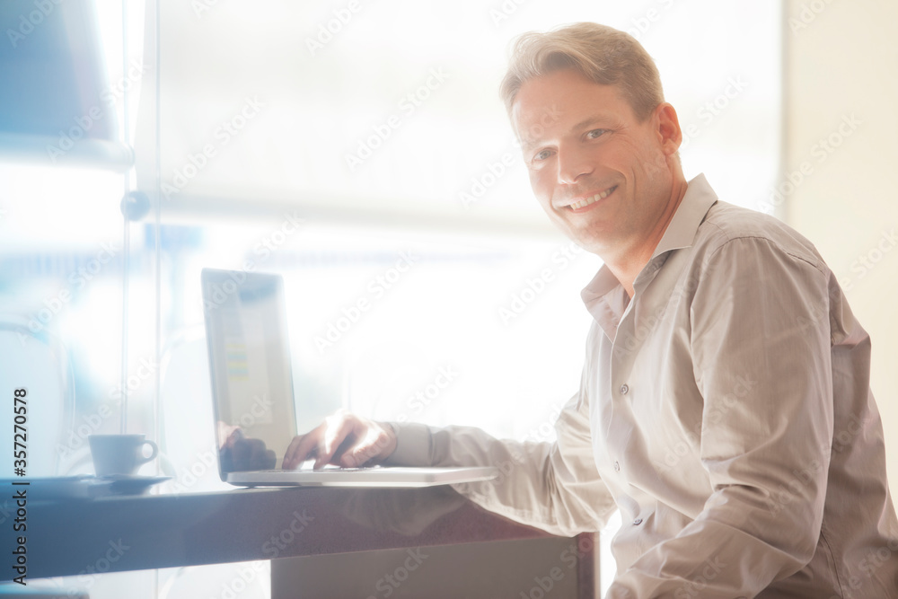 Businessman smiling at laptop Businessman smiling at laptop