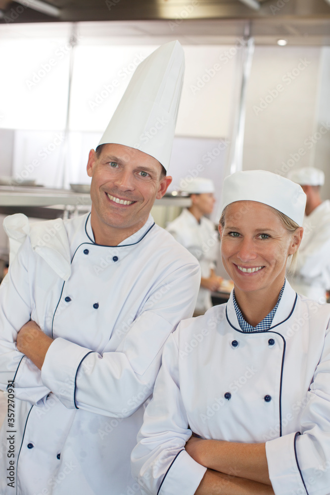 Chefs smiling in restaurant kitchen