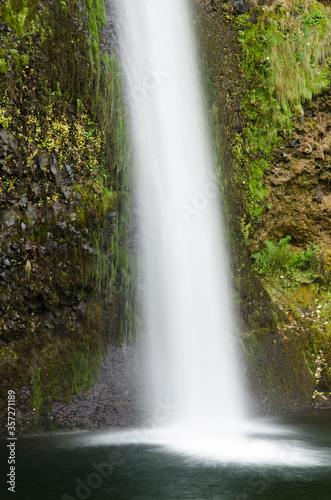 Waterfall emptying into still pool