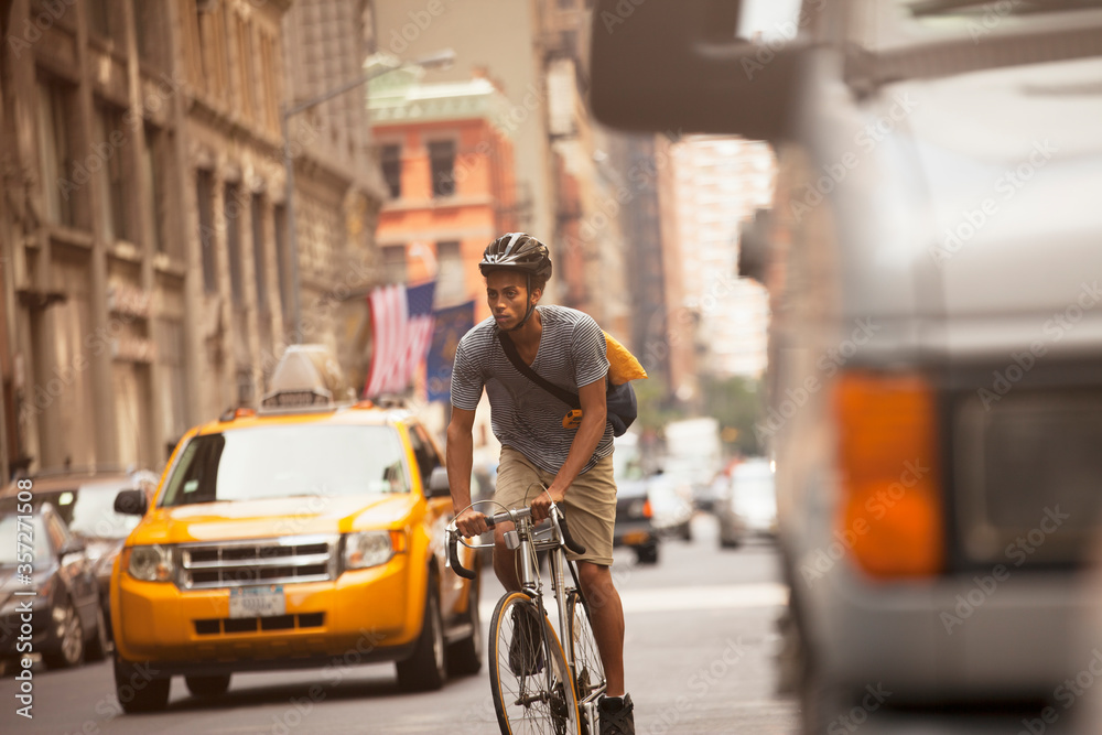 Man riding bicycle on city street