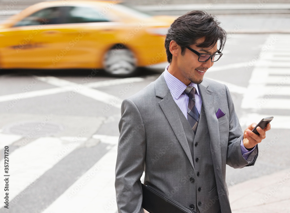 Businessman using cell phone on city street Businessman using cell phone on city street