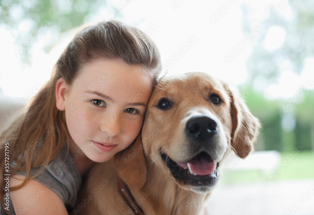 Girl hugging dog indoors Girl hugging dog indoors