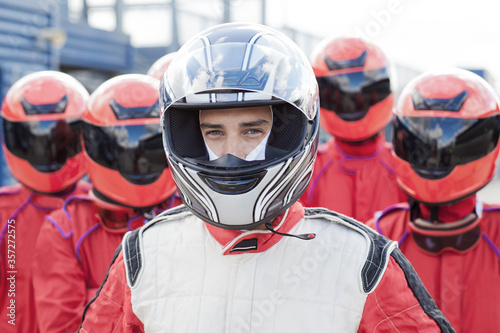 Obraz na plátně Racer with team standing outdoors