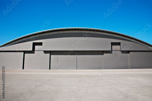 Curved roof of warehouse and blue sky