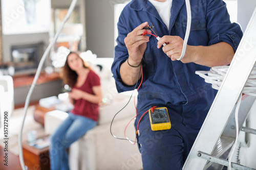 Electrician working in living room