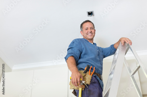 Man working on ceiling lights photo