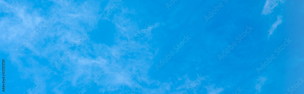 panoramic texture of white clouds on a blue sky. white haze in the sky as a background