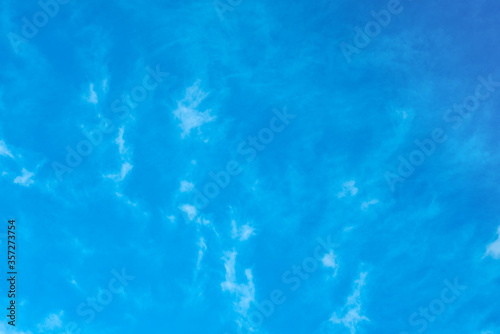Texture of white clouds on a blue sky. white haze in the sky as a background