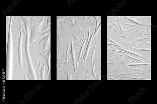 Fényképezés Three white crumpled sheets of paper on a black background.