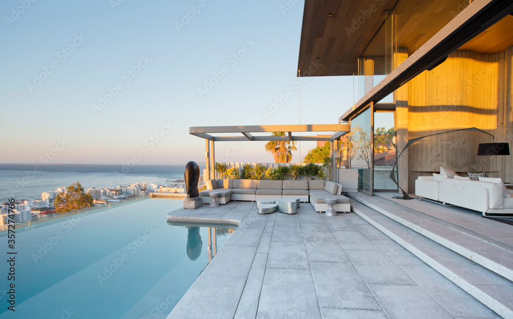 Infinity pool and patio of modern house - obrazy, fototapety, plakaty 