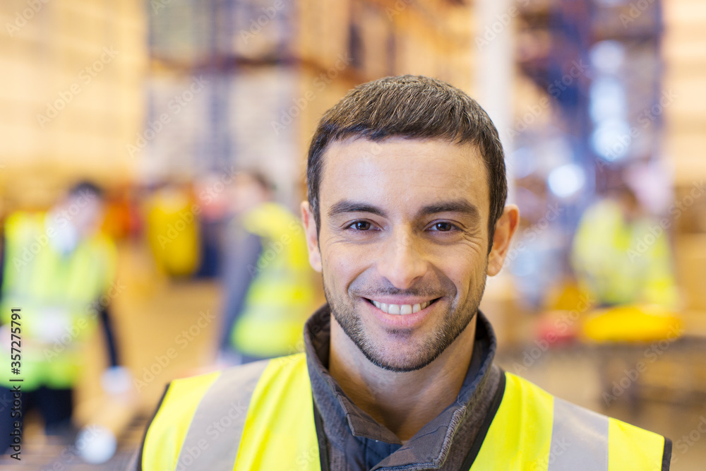 Worker smiling in warehouse Worker smiling in warehouse