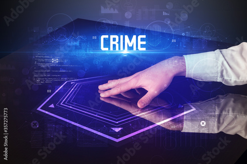 Hand touching digital table with CRIME inscription, new age security concept