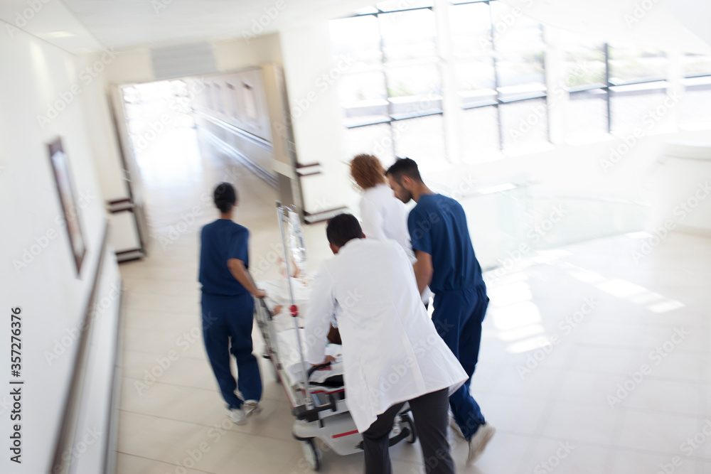Hospital staff rushing patient to operating room