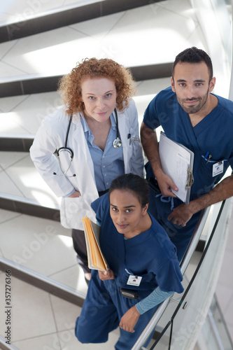 Doctor and nurses on hospital steps