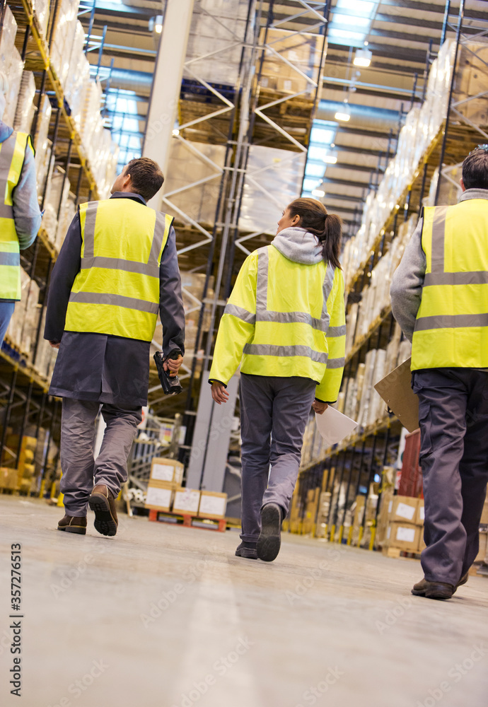 Workers walking in warehouse Workers walking in warehouse