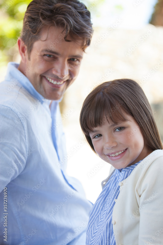 Father and daughter smiling outdoors Father and daughter smiling outdoors