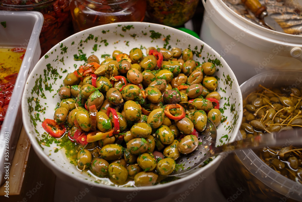 Salted olives in the store on the counter