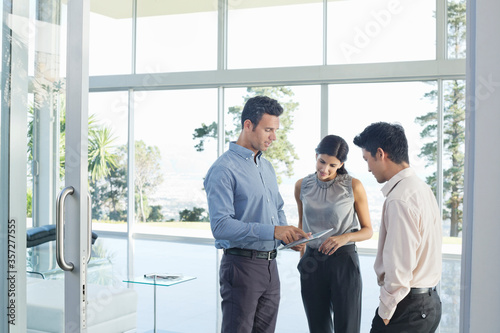 Business people using tablet computer in office