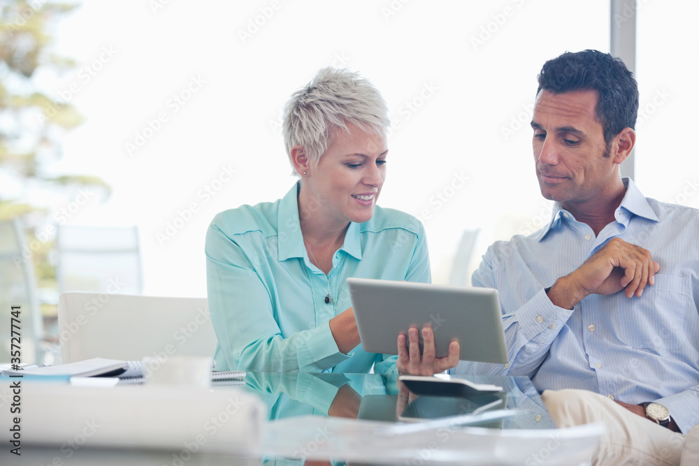 Business people using tablet computer on sofa Business people using tablet computer on sofa