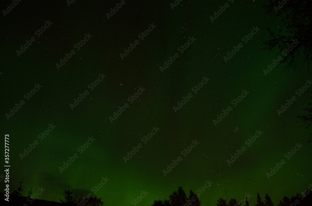 strong green aurora borealis and bright stars on autumn night strong green aurora borealis and bright stars on autumn night