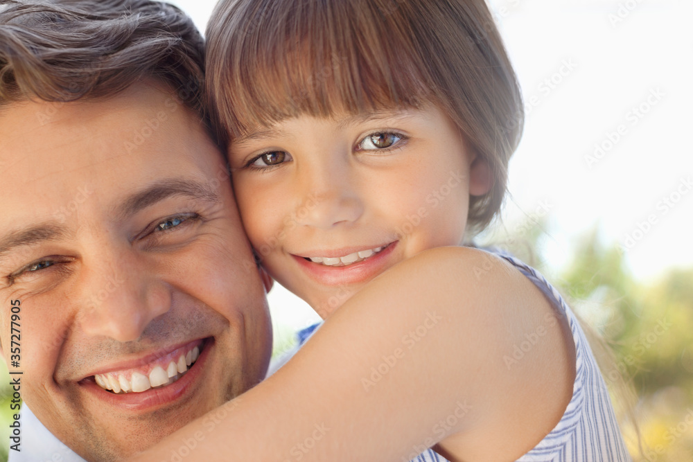 Father holding daughter outdoors Father holding daughter outdoors